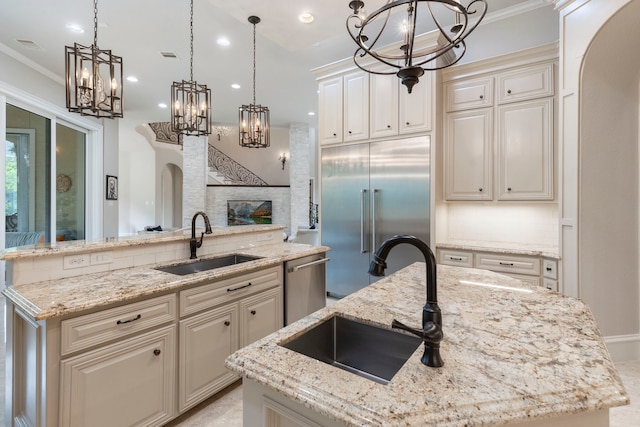 kitchen with a kitchen island, light stone countertops, sink, and appliances with stainless steel finishes