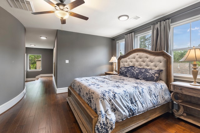 bedroom featuring multiple windows, ceiling fan, and dark hardwood / wood-style flooring