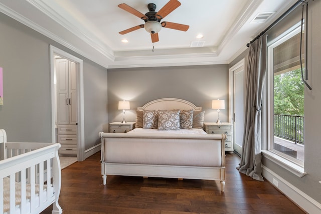 bedroom featuring a raised ceiling, multiple windows, and ceiling fan