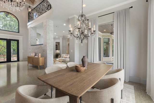 dining room with ceiling fan with notable chandelier, a towering ceiling, ornamental molding, and french doors