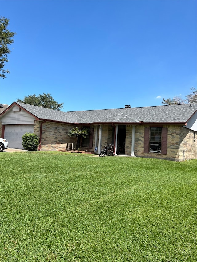 single story home with a front lawn and a garage