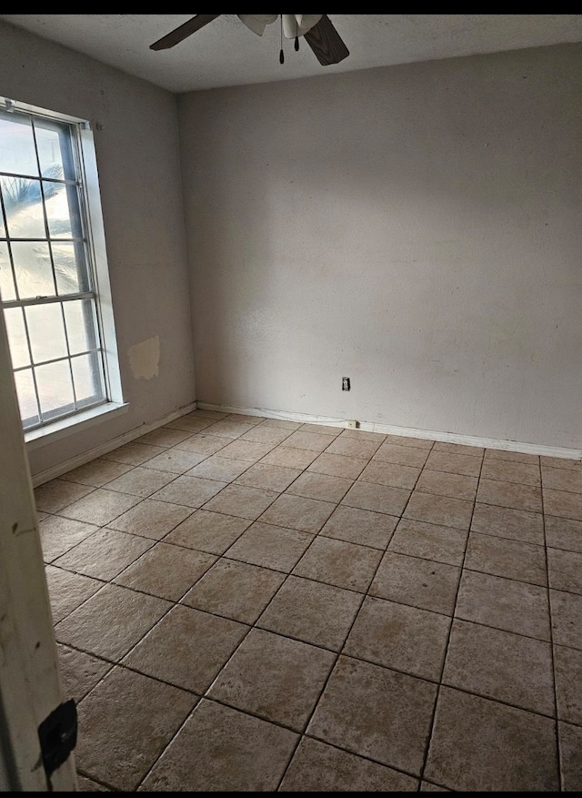 tiled empty room with a wealth of natural light