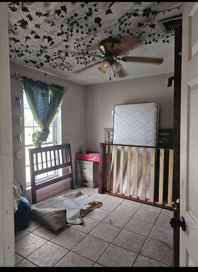 tiled bedroom featuring ceiling fan