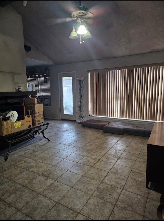 foyer entrance with ceiling fan and lofted ceiling