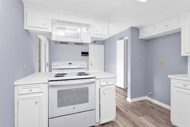 kitchen with white cabinets, light hardwood / wood-style flooring, and white appliances