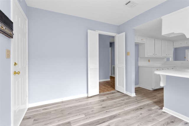 kitchen featuring white cabinetry and light hardwood / wood-style flooring