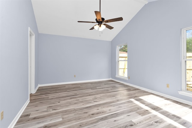 empty room with ceiling fan, light wood-type flooring, and high vaulted ceiling