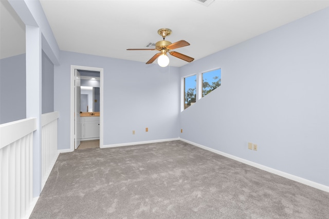 carpeted spare room featuring ceiling fan