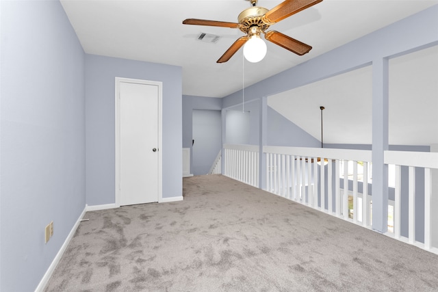 carpeted spare room featuring lofted ceiling and ceiling fan