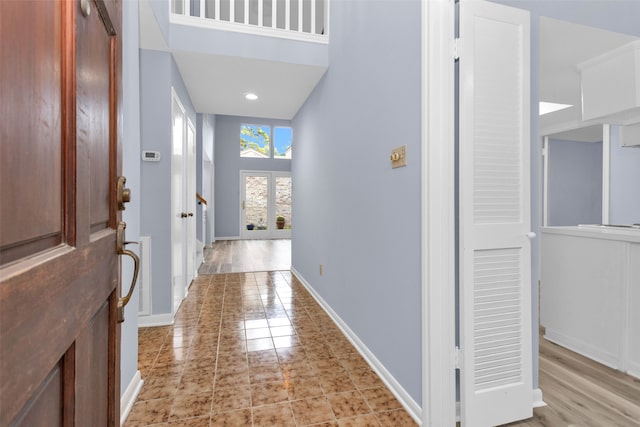 entrance foyer featuring a high ceiling and light wood-type flooring