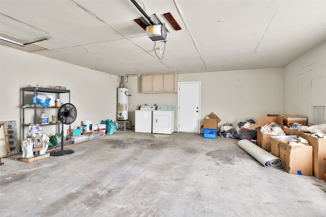 garage with gas water heater, independent washer and dryer, and a garage door opener