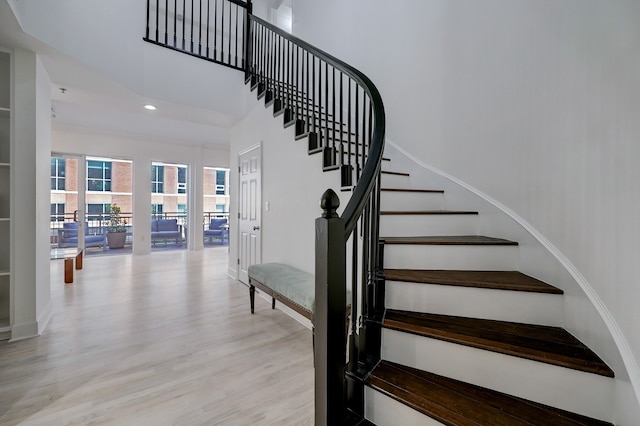 staircase with hardwood / wood-style flooring