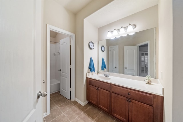 bathroom with vanity, tile patterned floors, and tiled shower