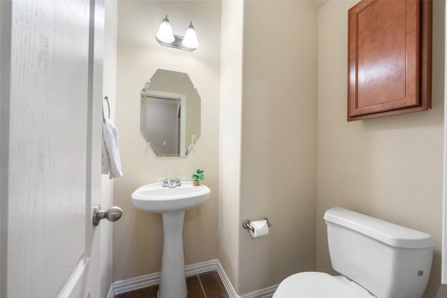 bathroom featuring tile patterned floors, toilet, and sink