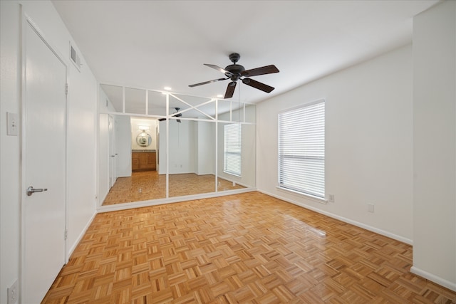 unfurnished bedroom featuring light parquet floors and ceiling fan