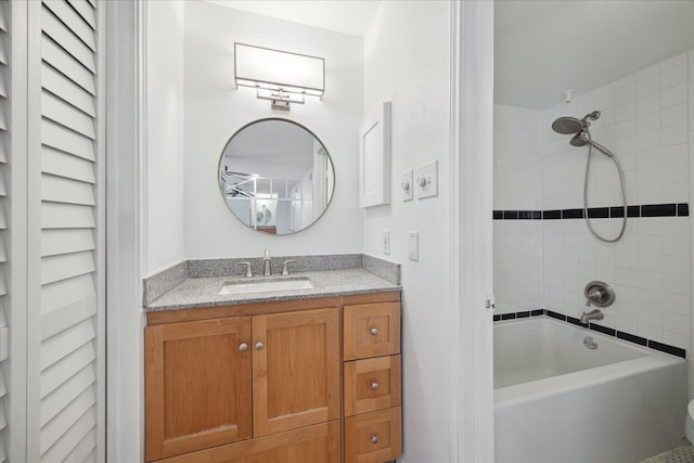 bathroom featuring vanity and tiled shower / bath