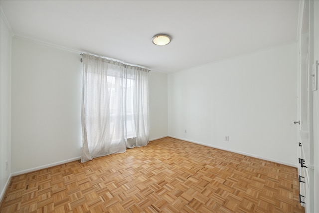 empty room with ornamental molding and light parquet floors