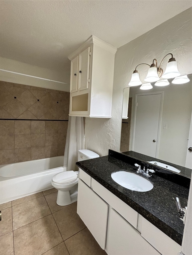 full bathroom with tile patterned flooring, a textured ceiling, vanity, toilet, and tiled shower / bath combo