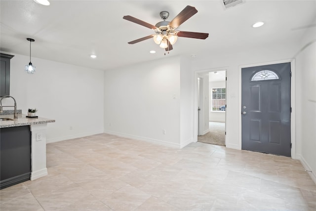 interior space featuring sink and ceiling fan