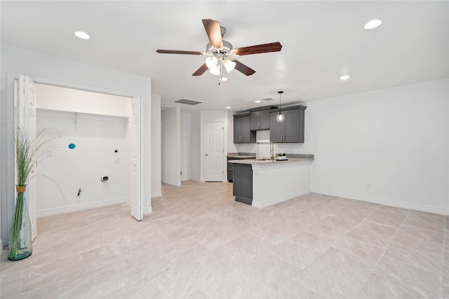 kitchen featuring kitchen peninsula, sink, and ceiling fan