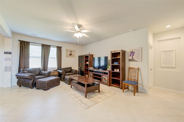 living room featuring light tile patterned floors and ceiling fan