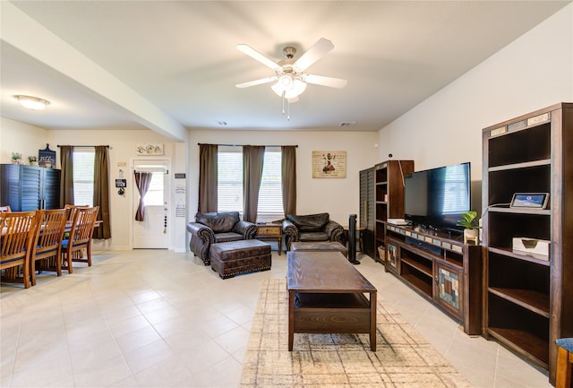 tiled living room with ceiling fan