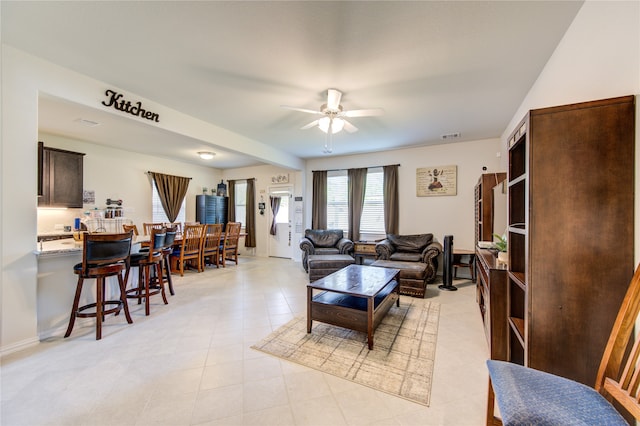 tiled living room featuring ceiling fan