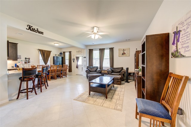 tiled living room featuring ceiling fan