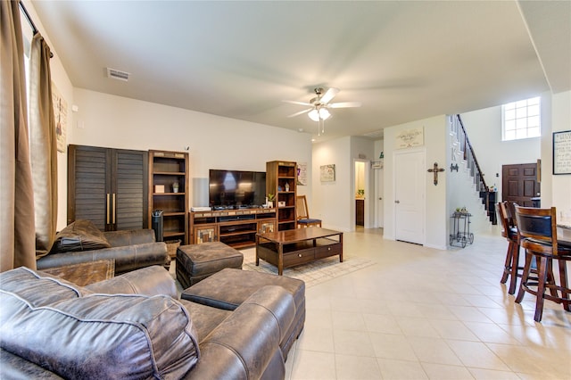 8438 Sunset Isles Dr, Baytown, TX 77521 - living area with a ceiling fan, stairway, and light tile patterned floors