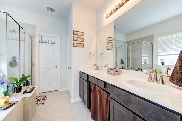 bathroom featuring vanity, tile patterned floors, and a shower with shower door