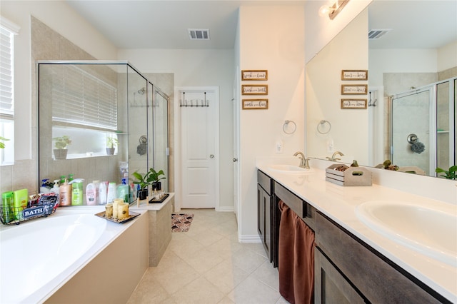 bathroom featuring tile patterned flooring, vanity, and shower with separate bathtub