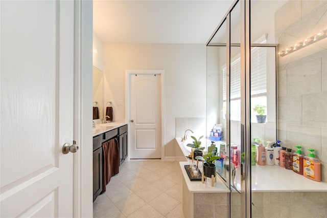 bathroom featuring tile patterned flooring, vanity, and plus walk in shower