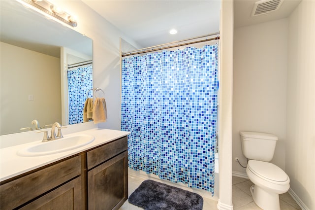 full bathroom featuring tile patterned flooring, vanity, toilet, and shower / bath combination with curtain