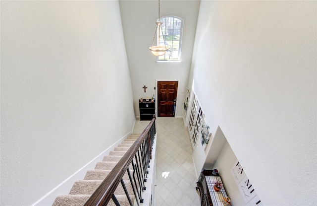 stairway with an inviting chandelier