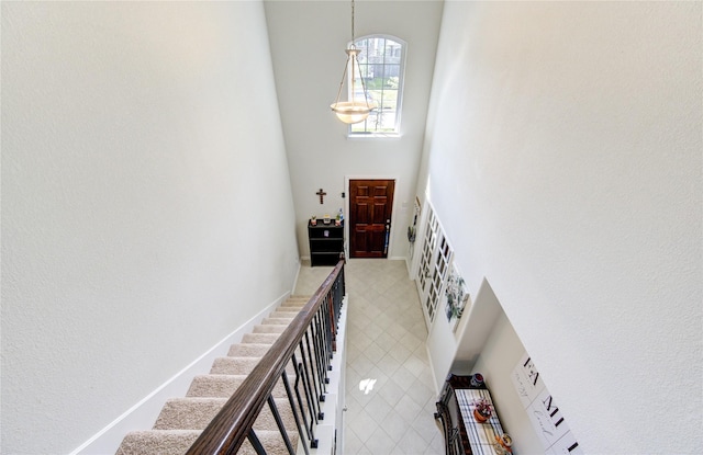 8438 Sunset Isles Dr, Baytown, TX 77521 - stairway with a towering ceiling and a chandelier