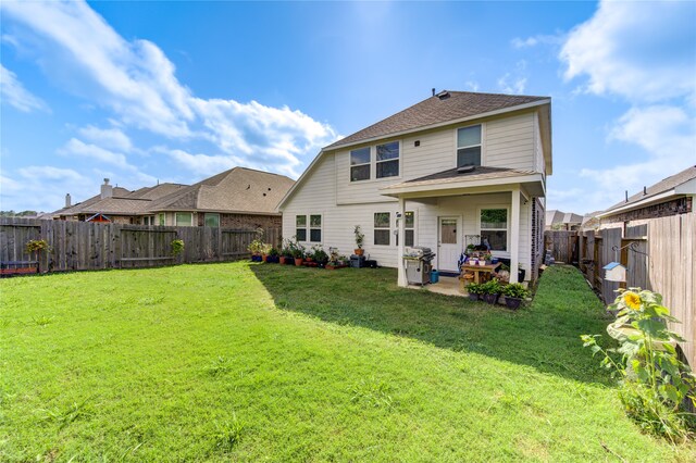 back of property featuring a patio and a yard