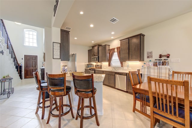 8438 Sunset Isles Dr, Baytown, TX 77521 - dining area with plenty of natural light, light tile patterned floors, recessed lighting, and stairway