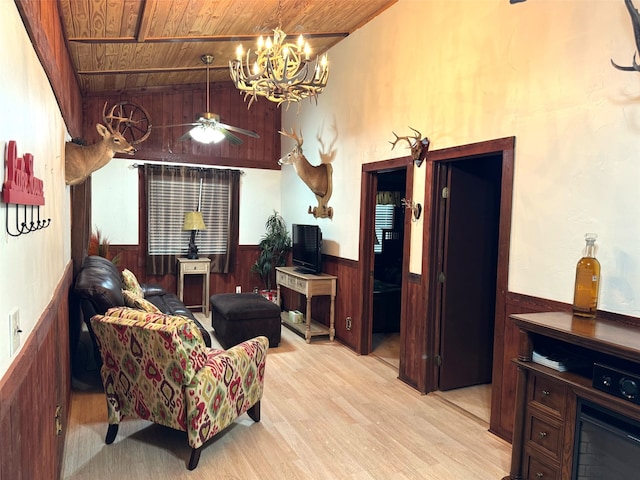 living room featuring wood walls, light wood-type flooring, and wooden ceiling