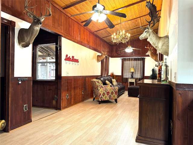 living area with wooden walls, wooden ceiling, light hardwood / wood-style floors, and a notable chandelier