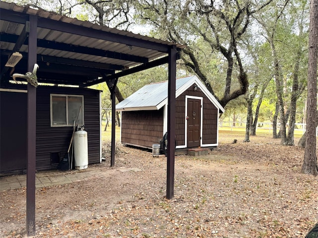 view of yard with a carport and a storage shed