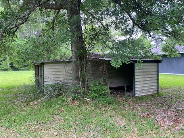 view of outbuilding featuring a lawn