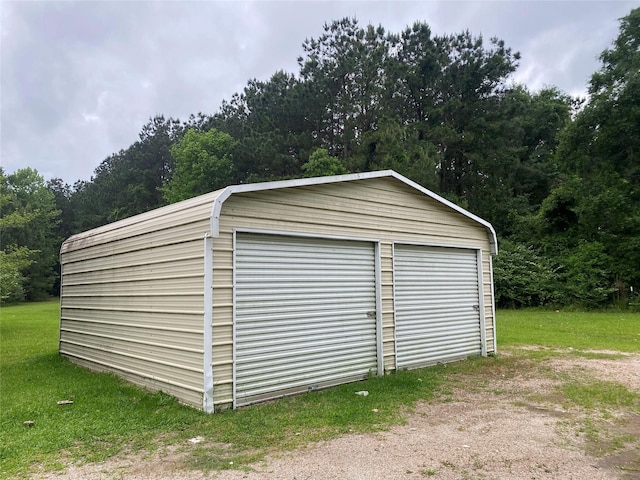 garage featuring a wooded view