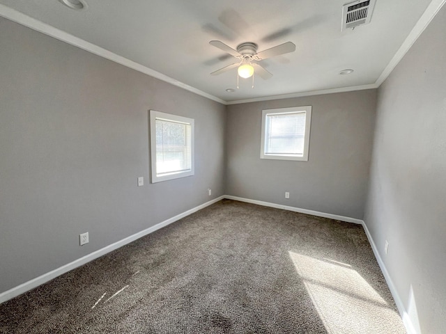 carpeted spare room featuring a ceiling fan, baseboards, visible vents, and ornamental molding