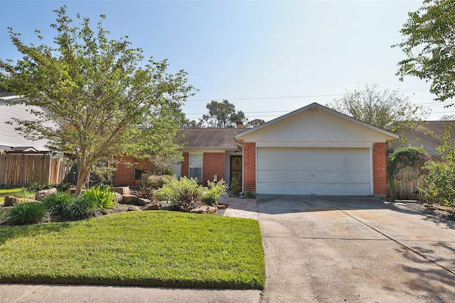 ranch-style home featuring a front lawn and a garage