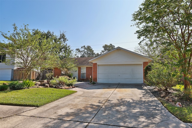 ranch-style home featuring a garage and a front yard