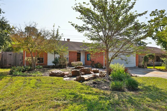 ranch-style home featuring a garage and a front lawn