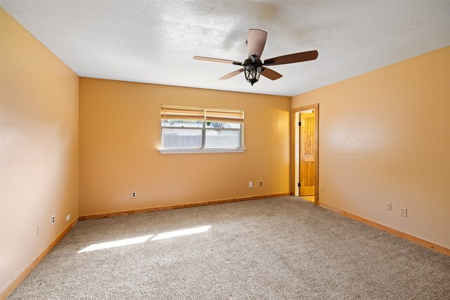 unfurnished room with carpet, a textured ceiling, and ceiling fan