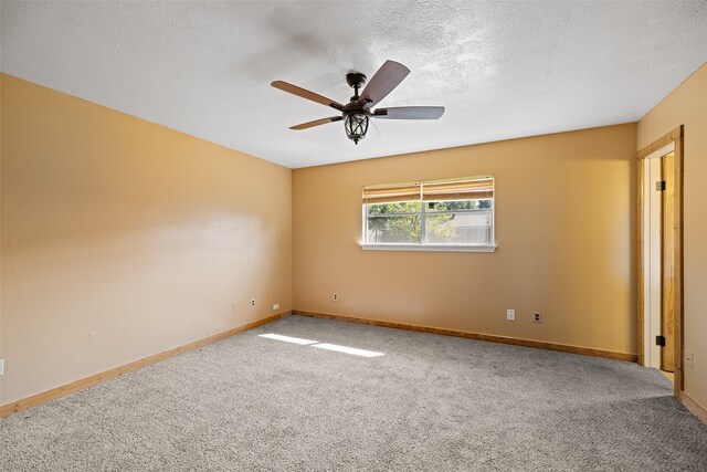 carpeted empty room with a textured ceiling and ceiling fan