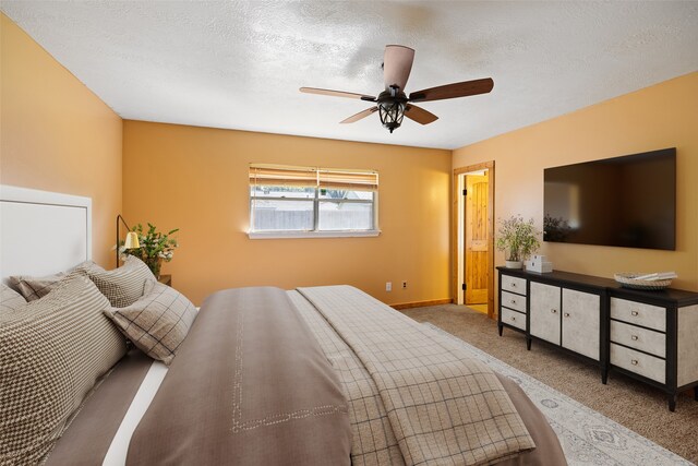 bedroom featuring ceiling fan, a textured ceiling, and carpet flooring