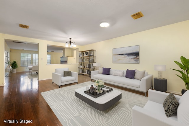 living room featuring hardwood / wood-style flooring and a chandelier